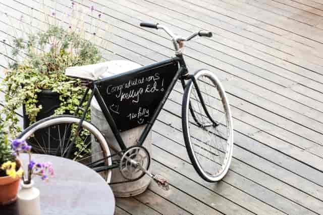 Rustic bicycle signage at White Dome wedding, ideal for outdoor event decor and photo spots.
