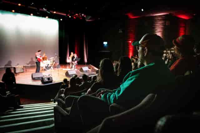 Picturehouse Central Screen 1: Proscenium stage and tiered theater seating for live events.