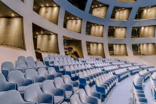 Modern auditorium at The Violin Factory with tiered seating for keynotes and plenary presentations.