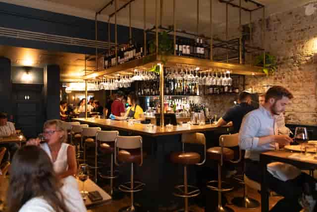 Wine cellar event space with industrial decor for corporate receptions and networking.