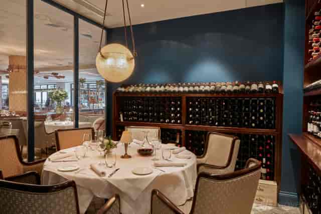 Private dining in Dehesa wine cellar with luxury table setting for VIP corporate events.
