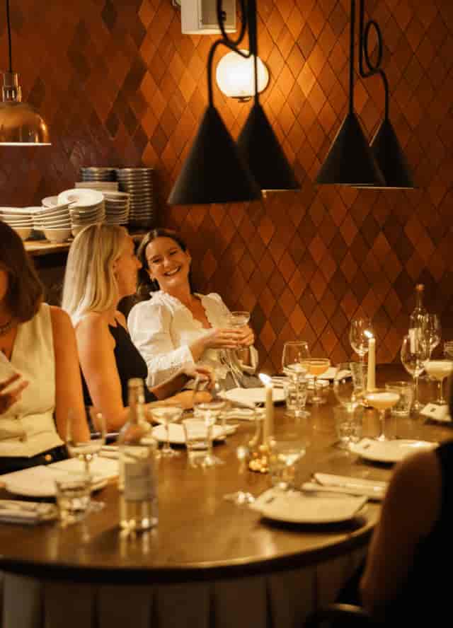 Henri Restaurant full hire, intimate corporate dinner venue with warm lighting for networking events.