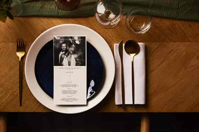 Bespoke Chef's Table place setting with personalized menu for luxury private dining events.