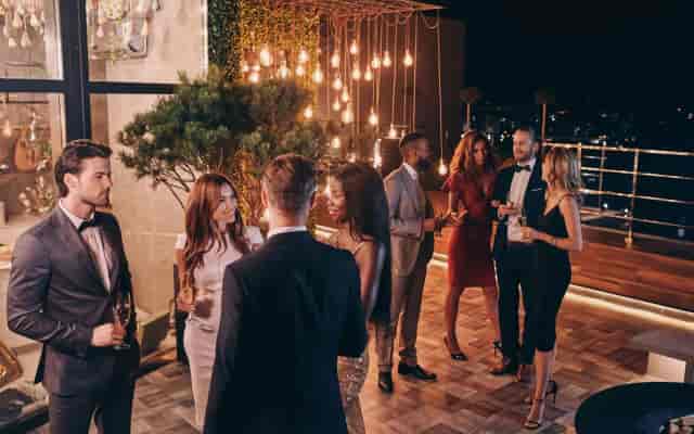 Luxury corporate networking reception at Limestone Rooftop with Edison bulb lighting.