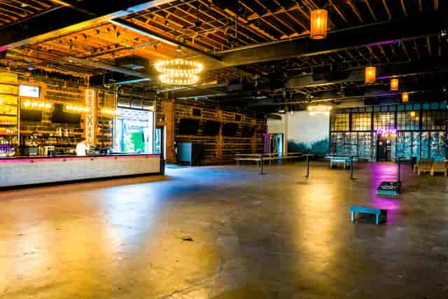 Industrial-chic LOFT 26 venue with built-in bar for networking and corporate events.