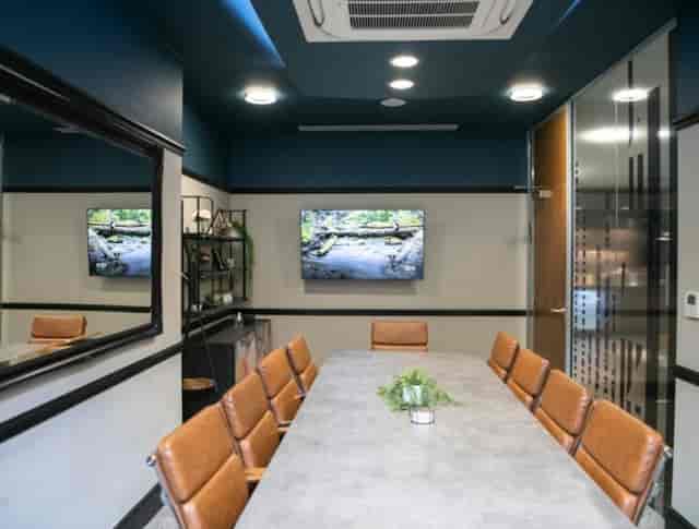 Trinity Suite boardroom with AV wall-mount for executive strategy meetings and corporate events.