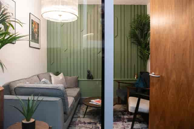 The Snug breakout room with lounge seating for strategy sessions and client meetings.