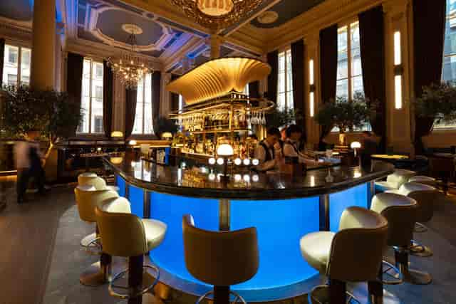 Edward Walters Suite: Elegant VIP networking venue with central bar for premium corporate events.