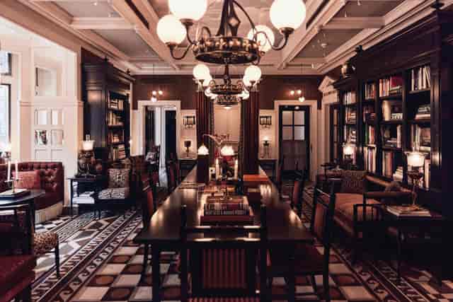 Cadogan Suite boardroom: library-inspired private venue for executive meetings and luxury dinners.