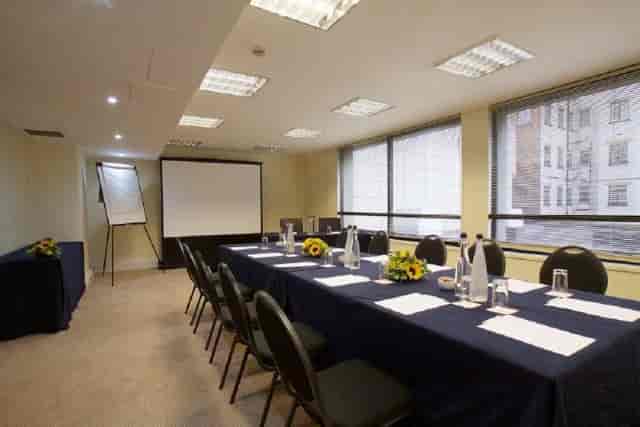 Belgravia Suite boardroom setup with AV equipment for corporate meetings and business events.