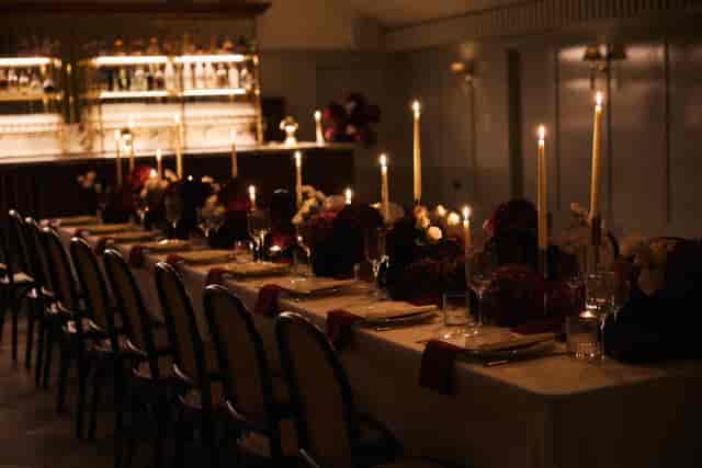 Long-table setup at ALBA London with candlelit floral decor for premium corporate private dining.