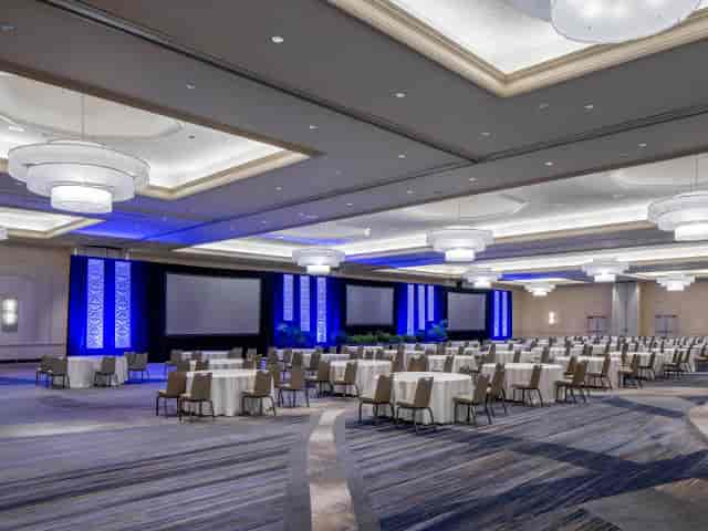 Hinterland ballroom event space with triple screens for corporate conferences and professional events.