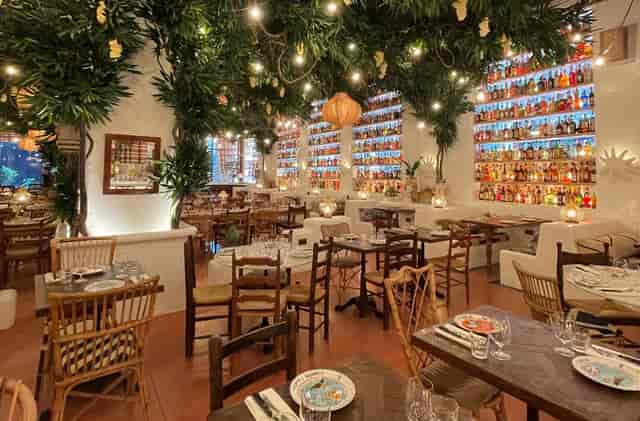 Illuminated bar in Circolo Popolare indoor courtyard for corporate dinners and event venues.