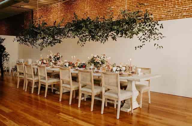 Industrial-chic event venue at The Sinclair with greenery, perfect for wedding receptions or galas.