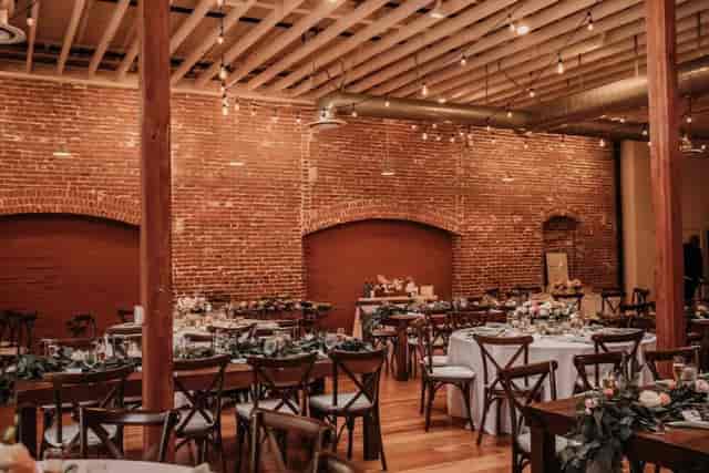 Industrial-chic event venue with exposed brick for weddings and corporate galas.