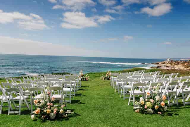 Outdoor wedding venue at The Sinclair with ocean views and aisle seating.