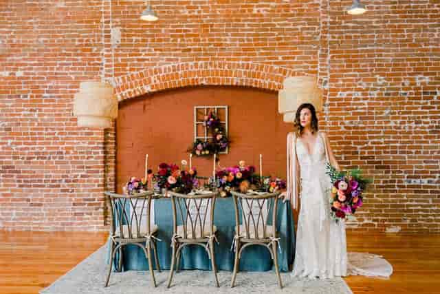 Sweetheart table with teal linens at The Pannikin Building industrial wedding venue.