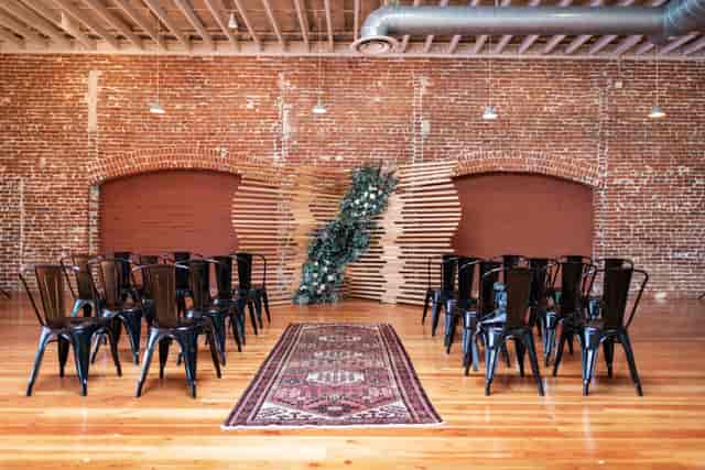 Industrial-chic Pannikin Building wedding ceremony with exposed brick and vintage decor.