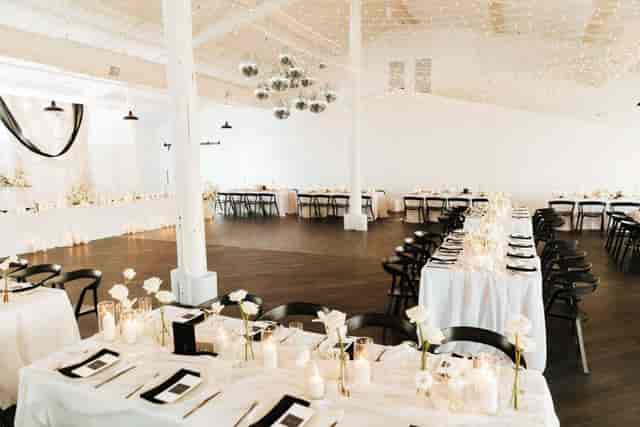 Industrial-chic Pannikin Building wedding reception venue with statement disco ball lighting.