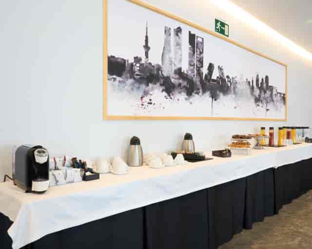 Coffee break station with white buffet setup at Hotel Puerta de Toledo for corporate event catering.