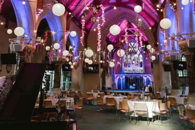 St Aldates Church with atmospheric lighting and floral decor for wedding or conference event.