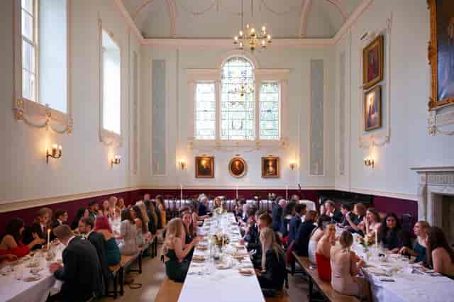 Worcester College dining hall formal banquet setup with long trestle tables for corporate events.