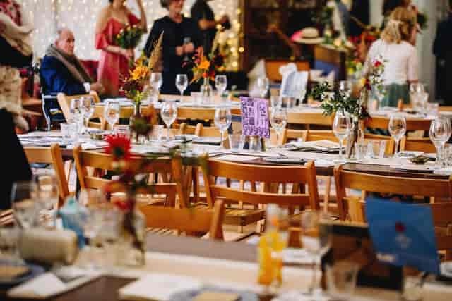 Rustic St Anne’s College dining hall with wooden tables for wedding receptions and events.