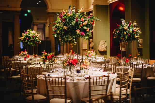 St Anne’s College dining hall gala with gold Chiavari chairs for luxury corporate events.