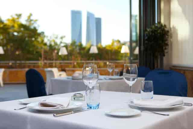 Minimalist terrace event space at Hotel Villamadrid with city skyline view for corporate meetings.
