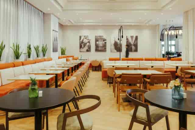 Atocha Room hotel event space with modular tables for corporate networking and breakout lunches.