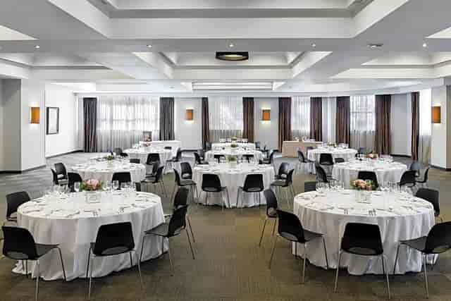 Cibeles Room at Rafaelhoteles Atocha with round tables for corporate and social events.