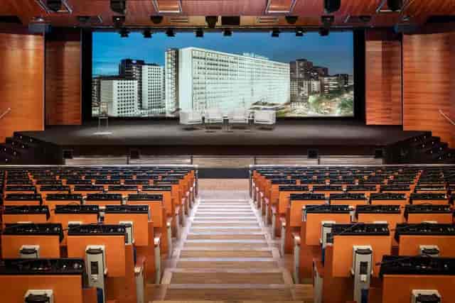 Prado Room auditorium with tiered seating for corporate keynotes and professional panel events.