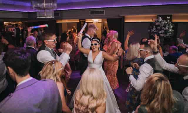 Purple-lit Grand Ballroom reception dance floor at The Redhurst Hotel event venue.