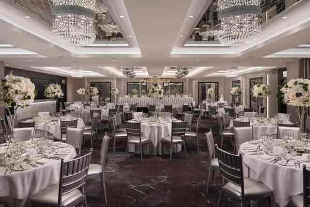 Luxury ballroom in Dalmeny Park House Hotel featuring tiered crystal chandeliers for gala weddings.