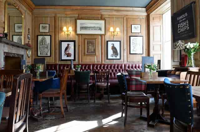 Wood-paneled pub interior at The Rupert Brooke, ideal for networking and team lunch events.
