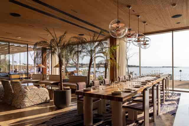 Caretta Riviera indoor lounge for executive retreats and VIP dinners with biophilic design.