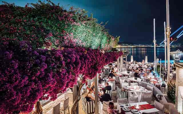 Beachfront outdoor gala venue with floral framing for corporate dinners and receptions.