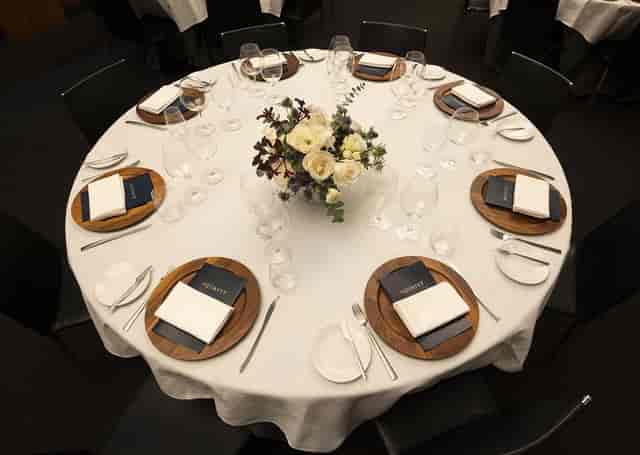 Linné Salon at Aquavit: Upscale gala table setting with floral centerpieces for corporate events.