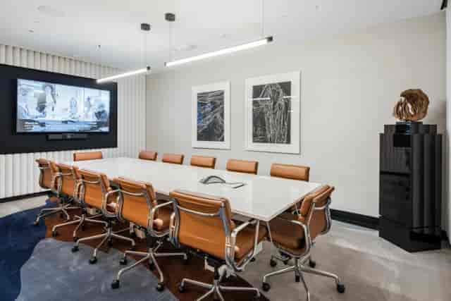 The Corner Room boardroom with leather seating for executive strategy sessions and hybrid meetings.