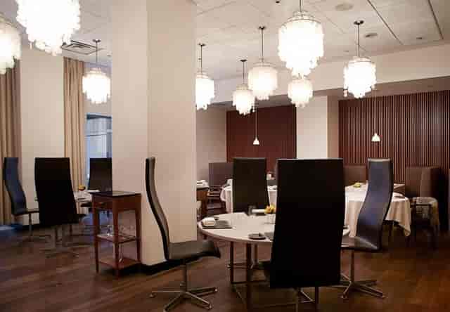 Upscale Nobel Room at Aquavit with high-backed seating for VIP lunches and executive board meetings.