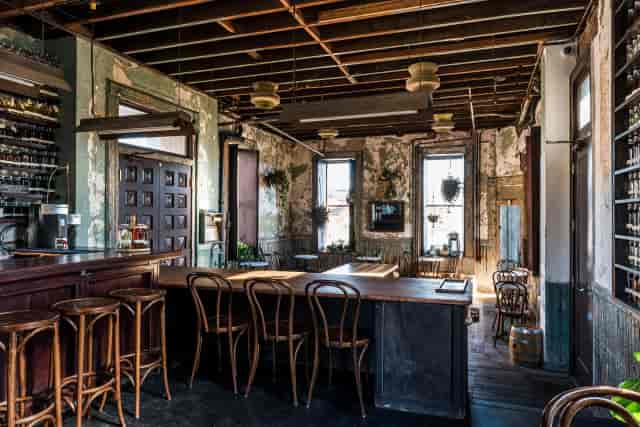 Industrial networking lounge with distressed walls for high-impact corporate reception events.