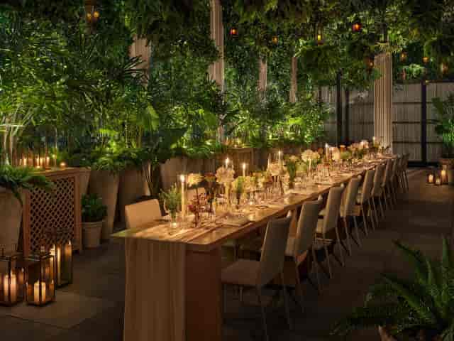 Garden West event dining with lush floral decor for exclusive luxury event planning.