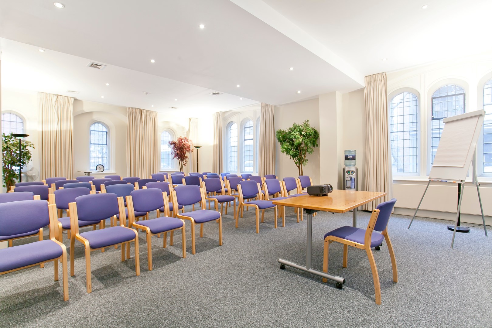 Trevelyan Hall meeting room with purple chairs, perfect for events and presentations.