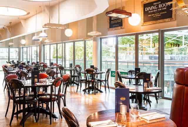 Semi-private dining room with natural light for corporate lunches and team events.