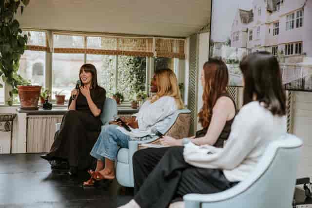 Panel discussion at Kin House Garden House with soft seating for intimate corporate events.