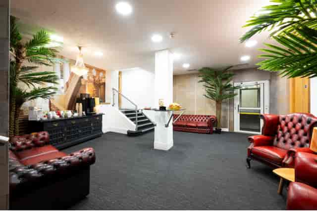 Westminster Suite foyer with chesterfield seating for corporate event networking and meeting space.