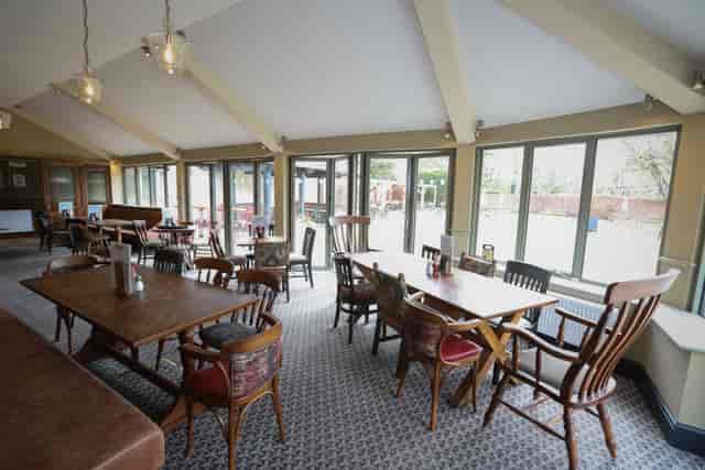 Conservatory at Red Lion: Modern event space with floor-to-ceiling windows for meetings and dining.