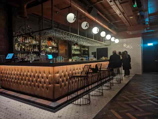 Slug & Lettuce Deansgate bar with tufted leather decor for corporate networking and VIP events.