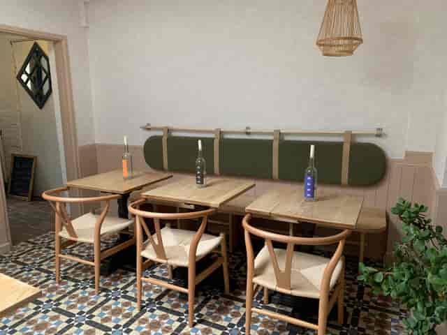 KASK Wine Bar: Intimate banquette seating and wishbone chairs for networking and event venues.