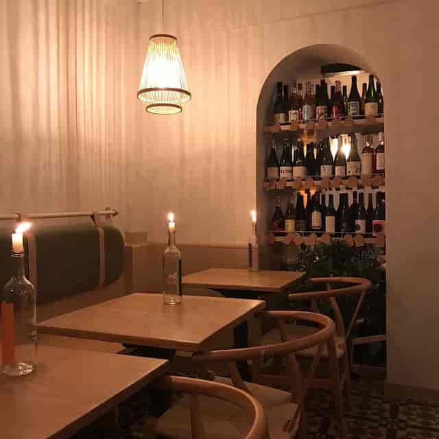 Kitchen by KASK intimate VIP dinner setup with ambient candle lighting for upscale networking.